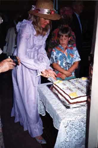 Sharon Hawke, secrétaire de l'association des femmes de Burgoyne Bay, entame le gâteau du Centenaire, en présence de?